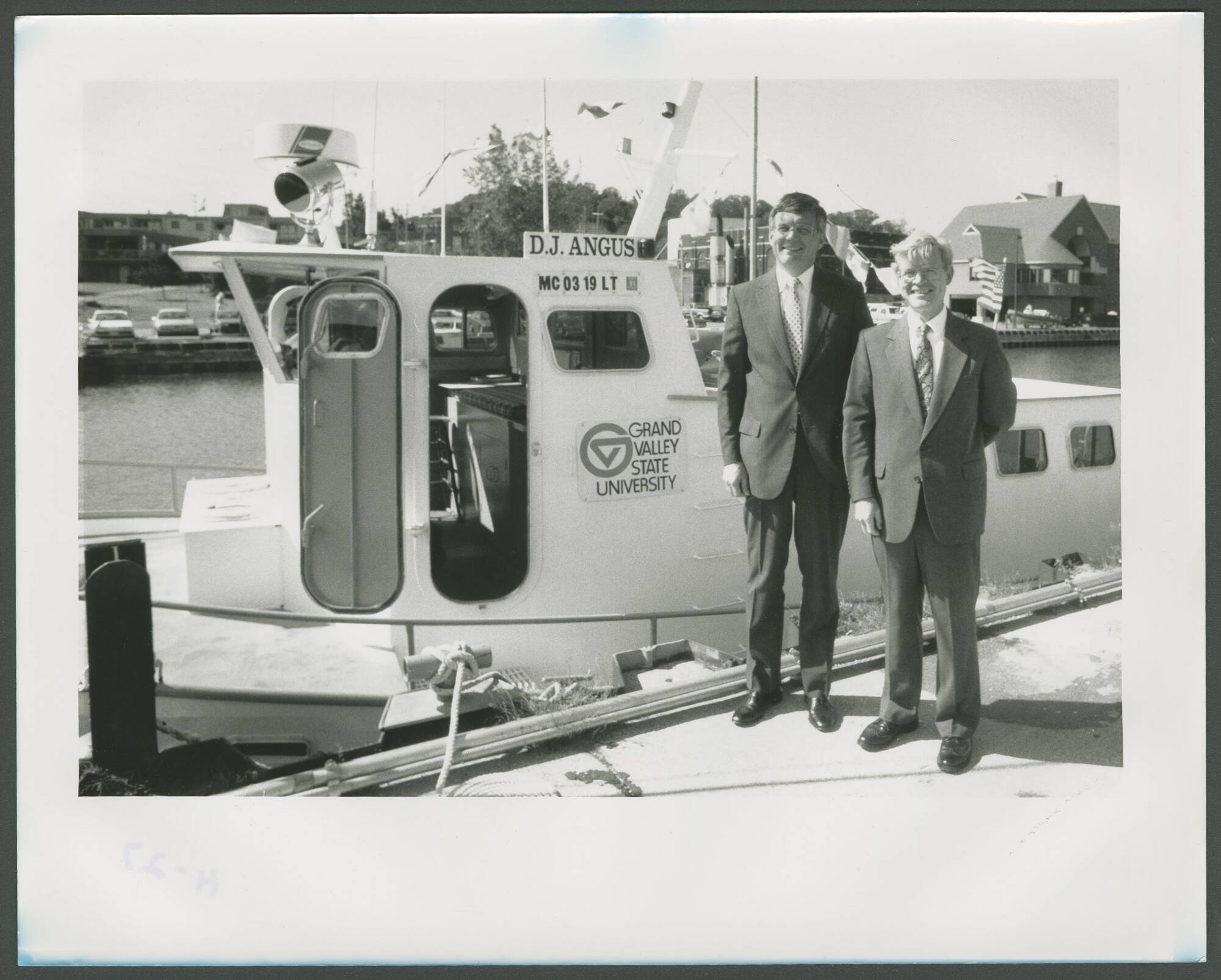 Ron Ward (right) poses at the D.J. Angus dock at Government Pond in Grand Haven.